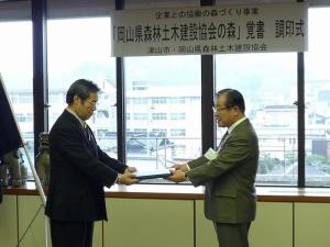 覚書をとり交わす坂本会長（左）と桑山市長（右）