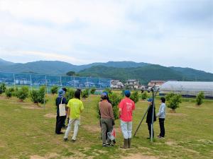 試験圃場にて研修に臨む農大生らを撮影した写真です